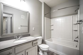 A white toilet sits next to a sink in a bathroom.