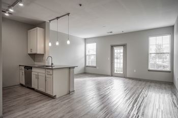 A spacious kitchen with wooden floors and a large island.