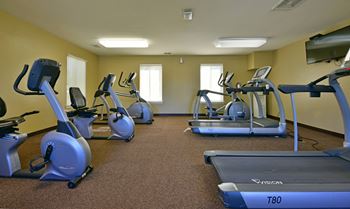 a gym with cardio equipment and exercise bikesat Windsor Place Apartments, Davison, MI
