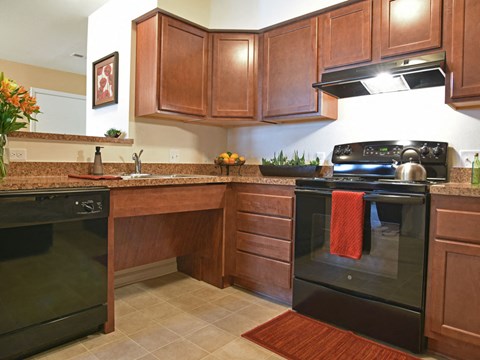 a kitchen with black appliances and wooden cabinets