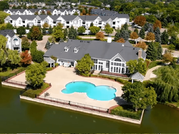 an aerial view of a house with an outdoor swimming pool in front of it  at Northport Apartments, Macomb, Michigan