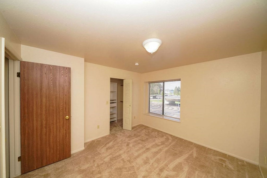 Bedroom with a walk-in closet with wardrobe organizers
