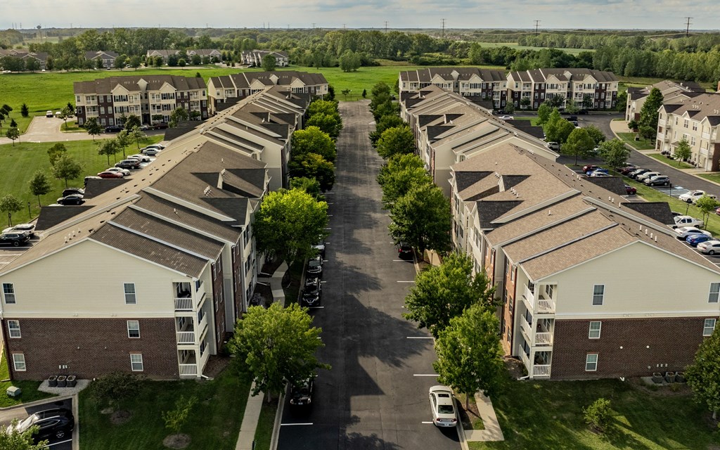 A large apartment complex with multiple buildings and parking lots