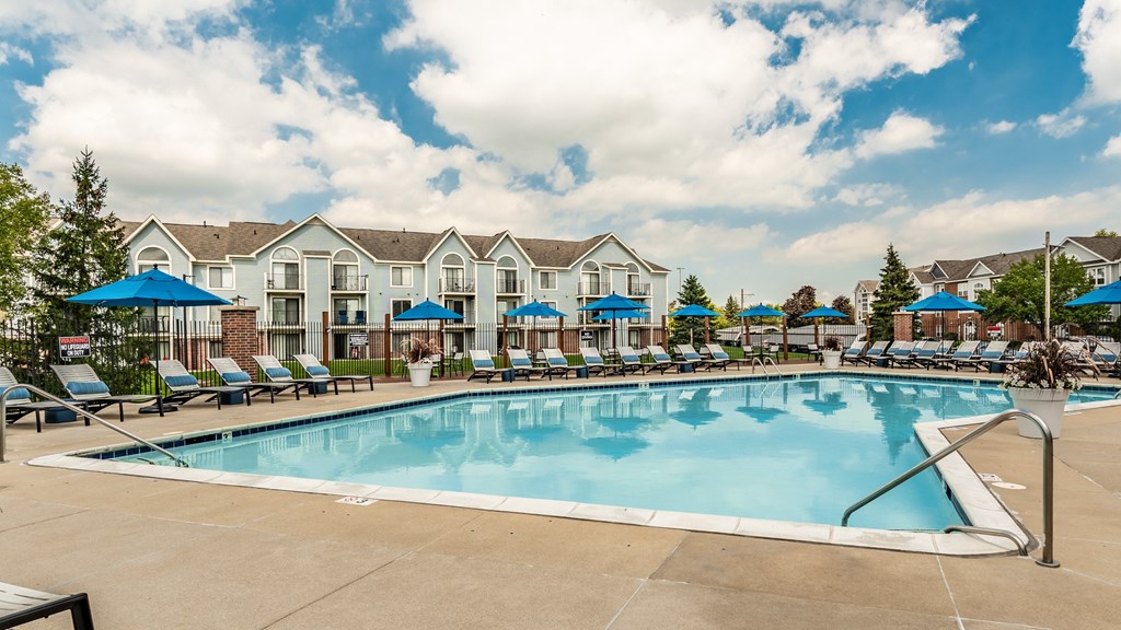 A large swimming pool in front of a resort