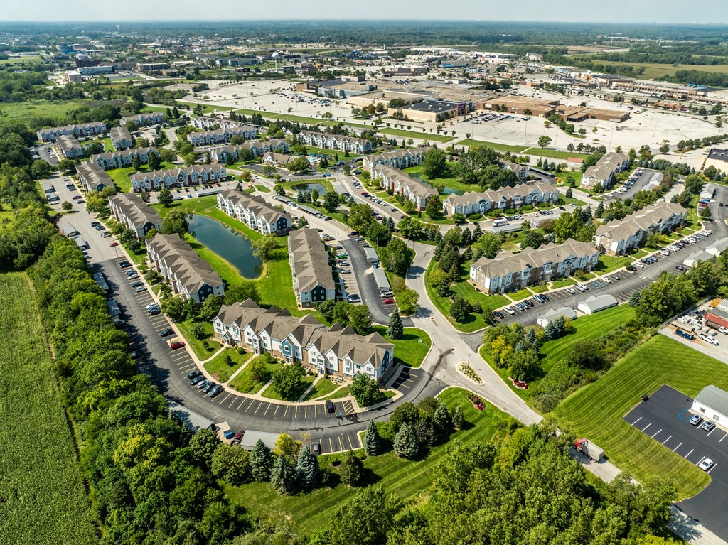 A bird's eye view of a residential area with houses and a roundabout