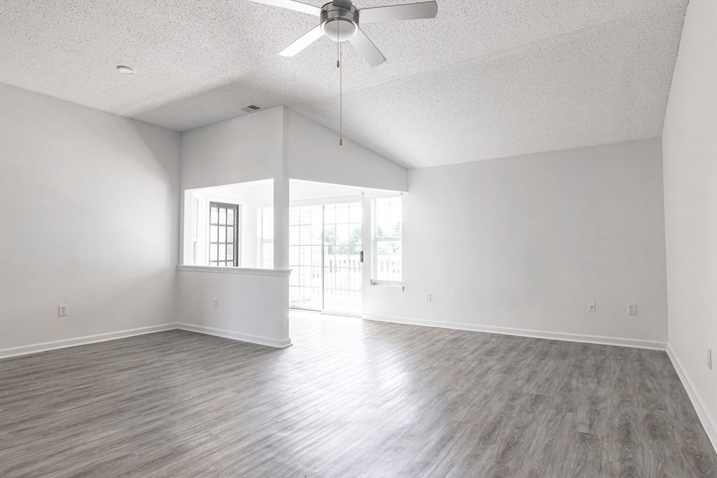 an empty living room with white walls and a ceiling fan at Latitudes Apartments, Indianapolis, IN, 46237