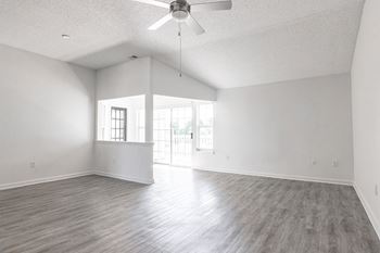 an empty living room with white walls and a ceiling fan at Latitudes Apartments, Indianapolis, IN