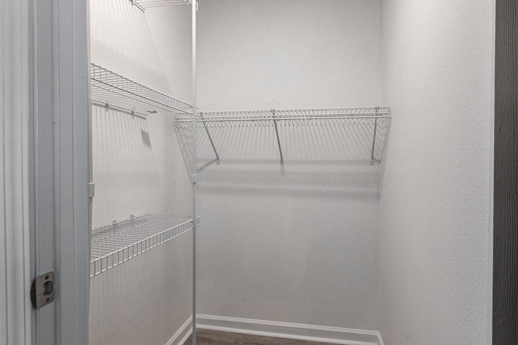 an empty walk in closet in a white room with white walls and a white door at Latitudes Apartments, Indianapolis, Indiana