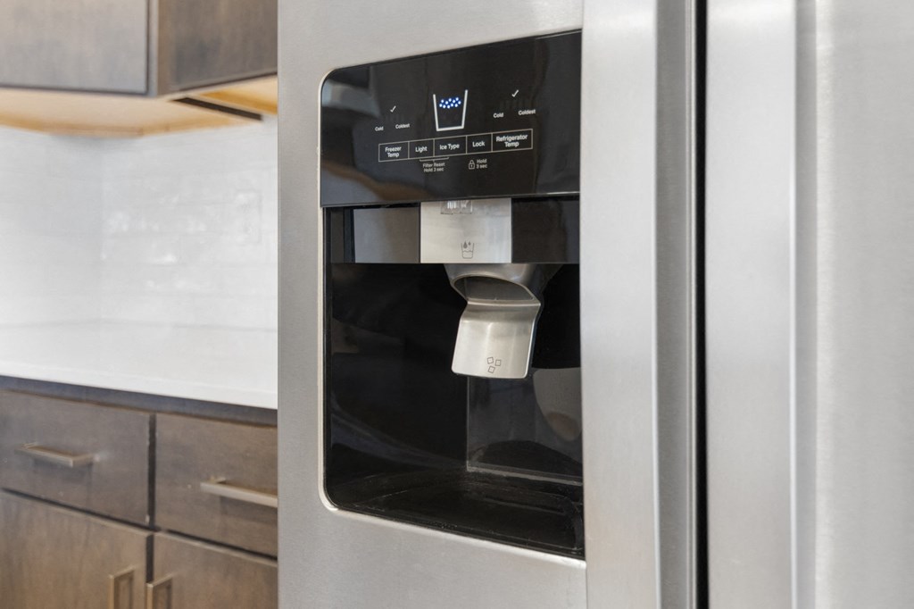 a stainless steel refrigerator with a coffee dispenser in a kitchen in Carmel, IN, 46032
