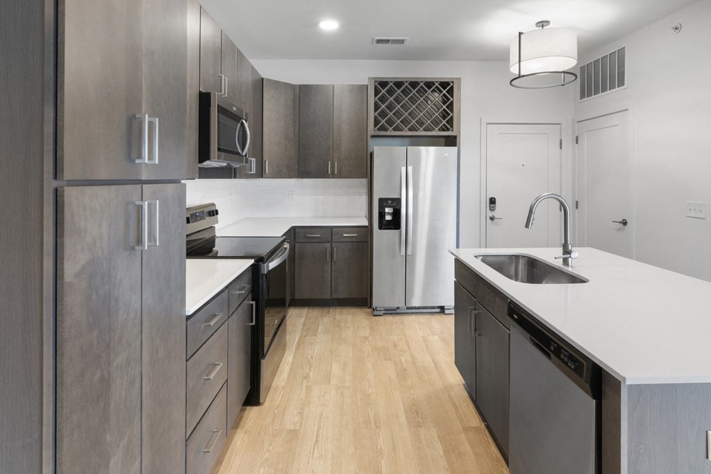 a renovated kitchen with stainless steel appliances and white counter tops in Carmel, IN