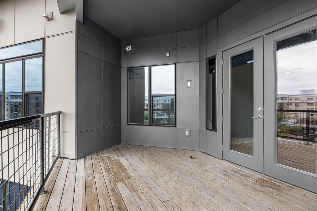 apartment balcony with wood floors and glass doors in Carmel, IN