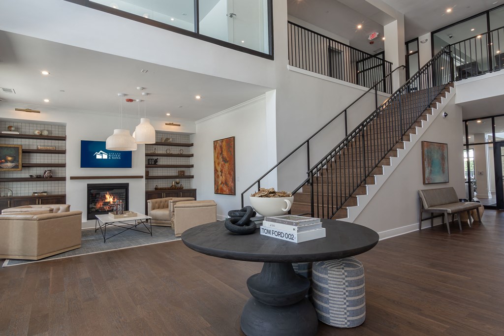 a living room with a fireplace and a staircase