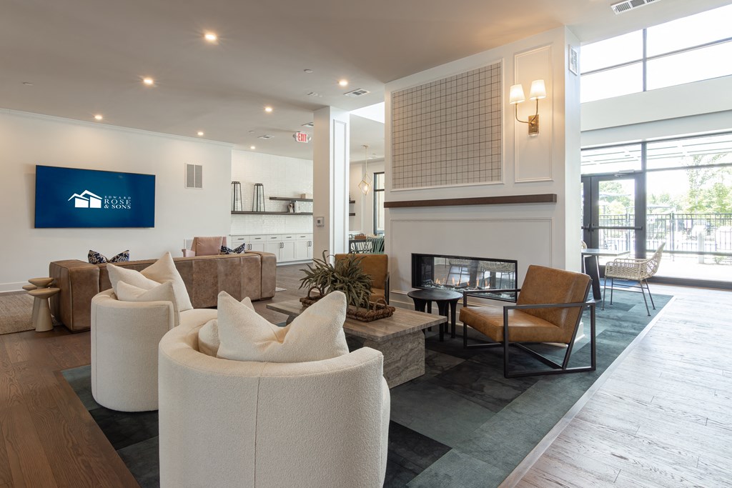 a living room with couches and chairs and a fireplace