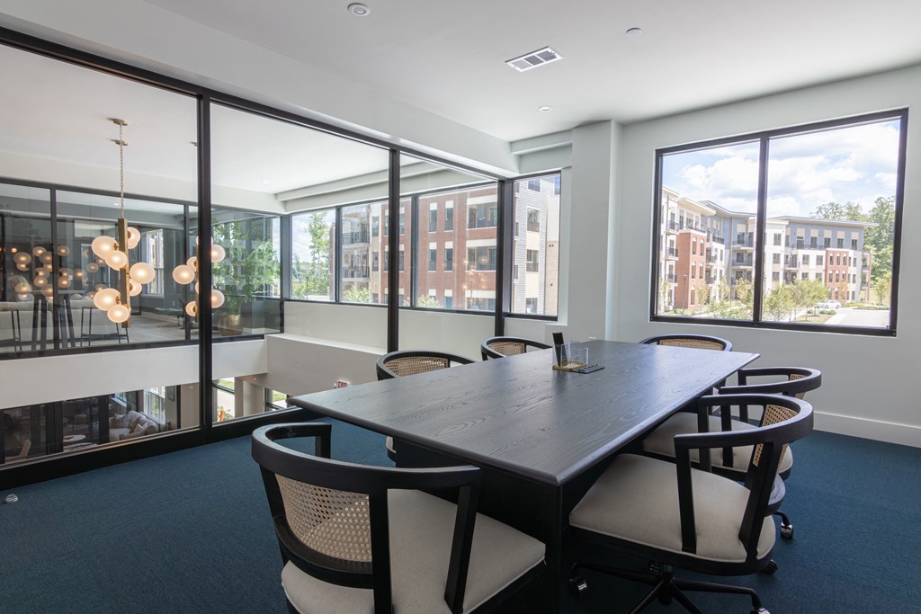 a conference room with large windows and a table and chairs