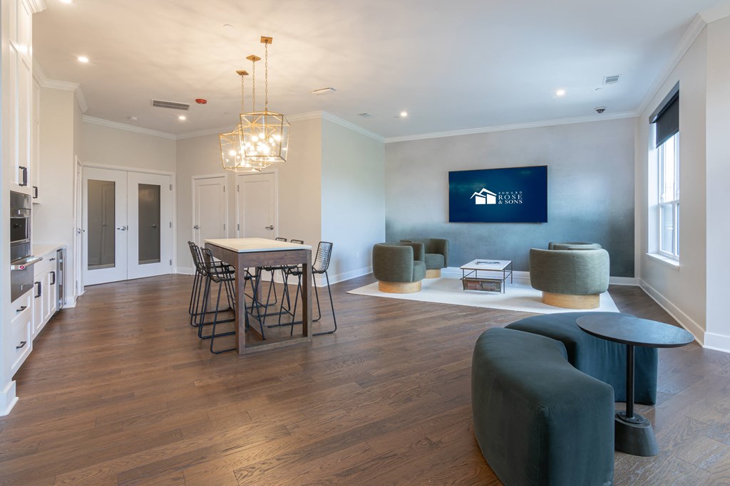 a living room with a dining room table and chairs and a kitchen
