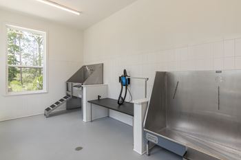 A clean, empty room with a large sink and a window at Luxe 360 on Centerpointe Apartments, Midlothian, Virginia