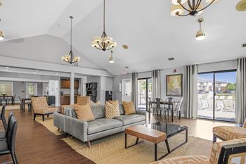 A living room with a grey couch at Bay Pointe Apartments, Indiana