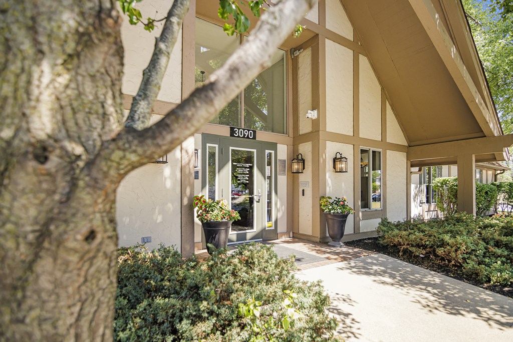 a building with a tree in front of it at Pheasant Run Apartments, Lafayette, IN