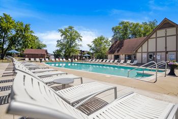 Resort style swimming pool with chaise lounge chairs and trees in the background  at Pheasant Run, Indiana, 47909