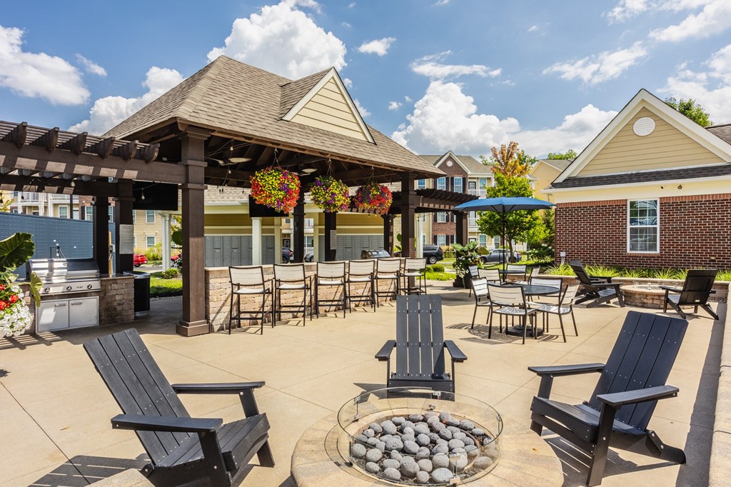an outdoor patio with chairs and tables and a pavilion at The Avenue at Polaris Apartments, Columbus, OH