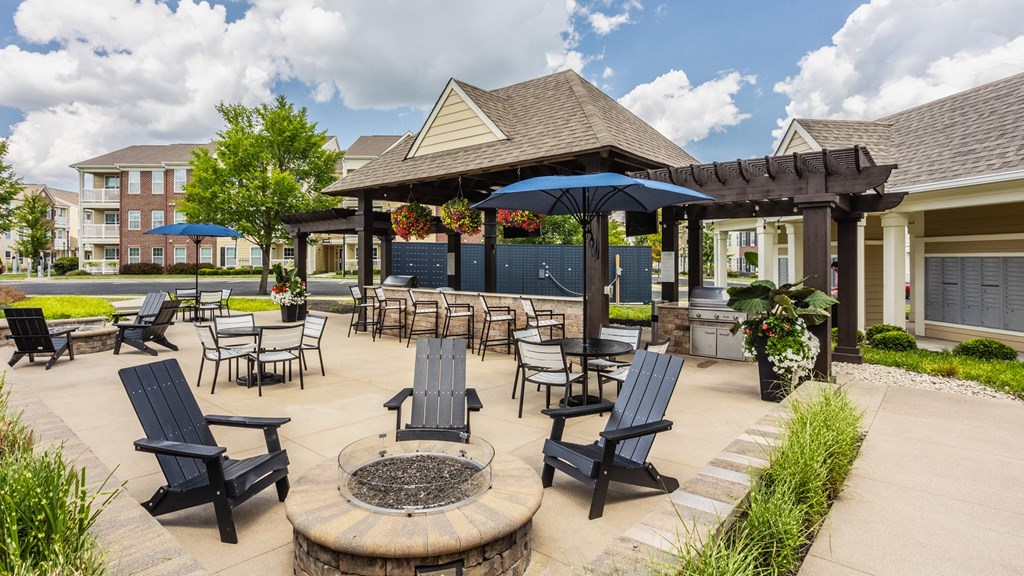 an outdoor patio with tables and chairs and a pavilion with umbrellas at The Avenue at Polaris Apartments, Columbus, OH