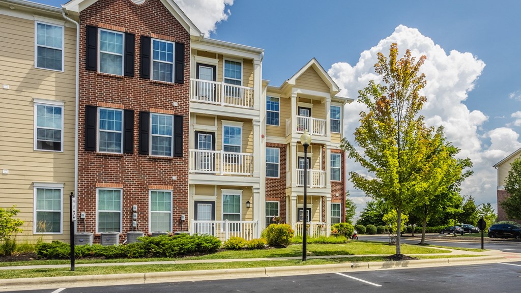 a row of apartment buildings on the corner of a street at The Avenue at Polaris Apartments, Columbus, OH