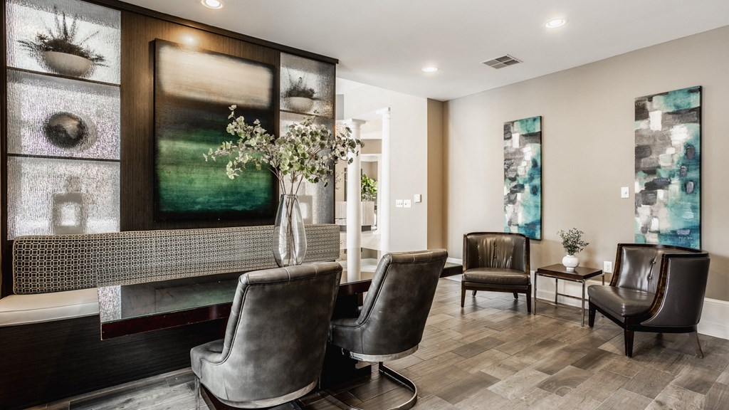 a living room with leather chairs and a fireplace at The Avenue at Polaris Apartments, Columbus, OH