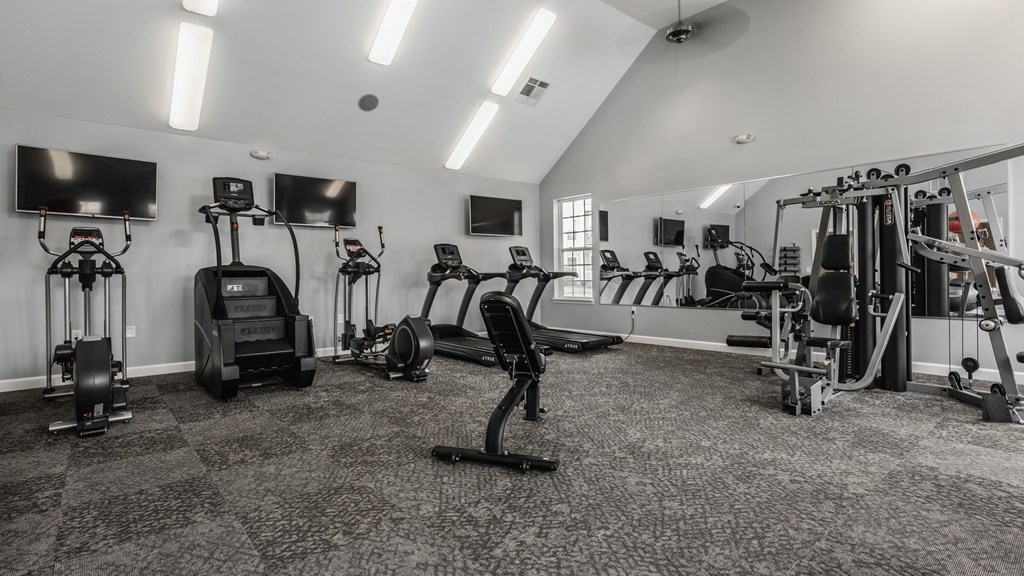 a gym with cardio machines and televisions in a building at The Avenue at Polaris Apartments, Columbus, OH