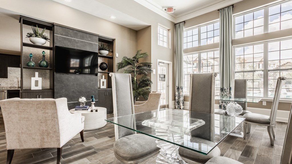 a living room with a glass table and chairs at The Avenue at Polaris Apartments, Columbus, OH