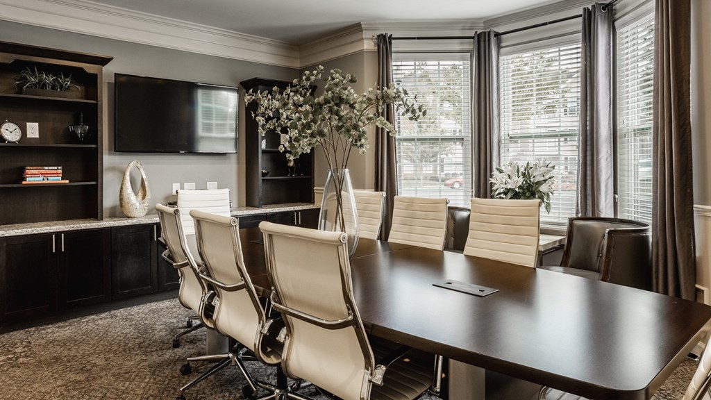 a dining room with a large table and chairs and a tv at The Avenue at Polaris Apartments, Columbus, OH