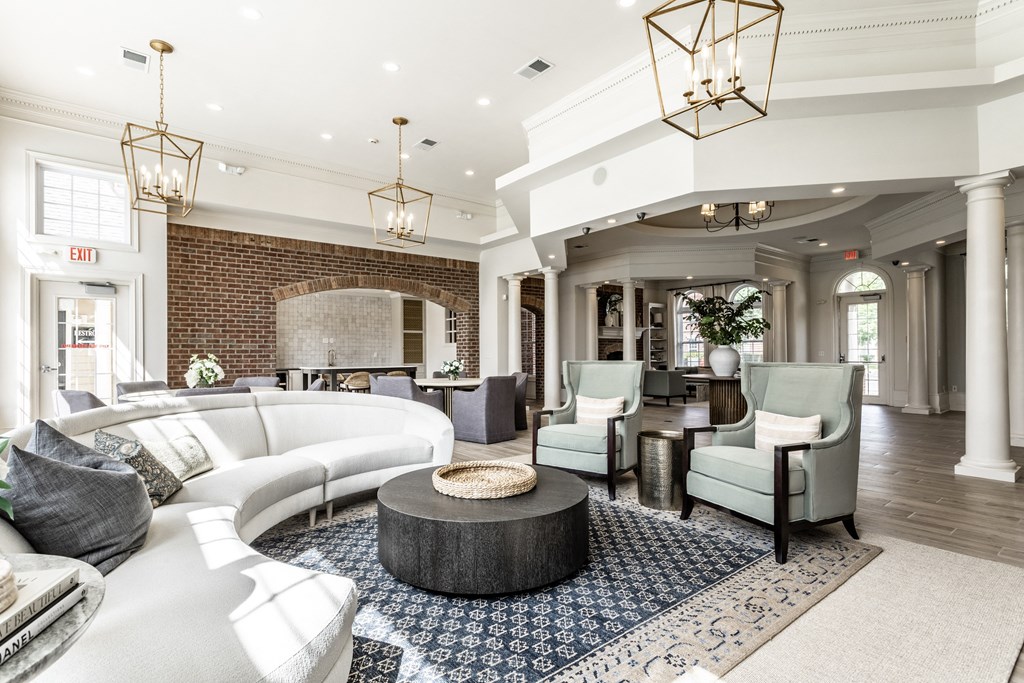 Couch chairs and chandeliers in clubhouse at Alexandria of Carmel Apartments, Carmel, IN