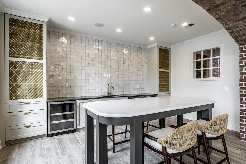 Kitchenette with island and tile backsplash at Alexandria of Carmel Apartments, Carmel