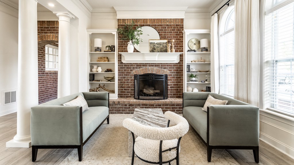 Green couches and fireplace in clubhouse at Alexandria of Carmel Apartments, Indiana