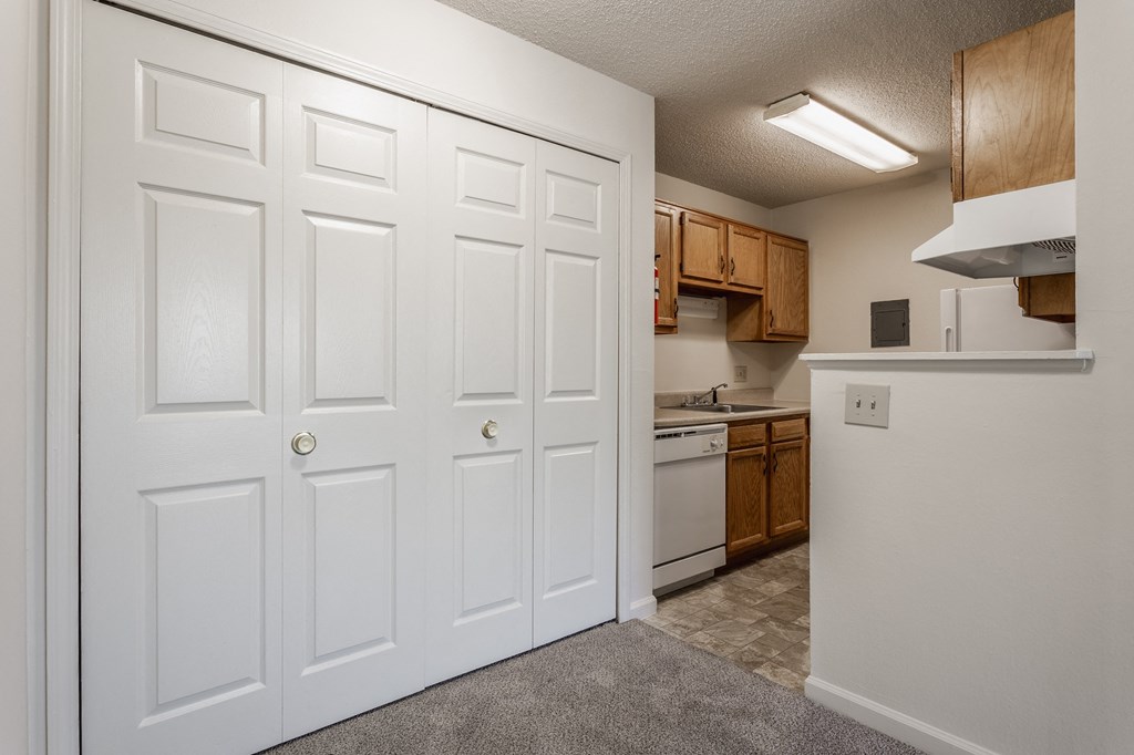 a kitchen with white doors and brown cabinets at Bavarian Village Apartments, Indiana