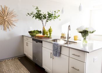 White Linen Cabinetry with Soft Grey Quartz and White Backsplash at Bella Vista Apartments, Fishers, IN, 46038