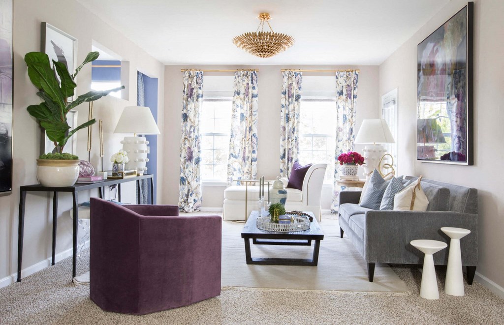 a neutral living room with purple accents  at Enclave Apartments, Midlothian, VA