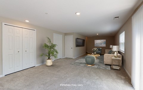 a living room with a couch and a tv  at Killian Lakes Apartments and Townhomes, Columbia, SC