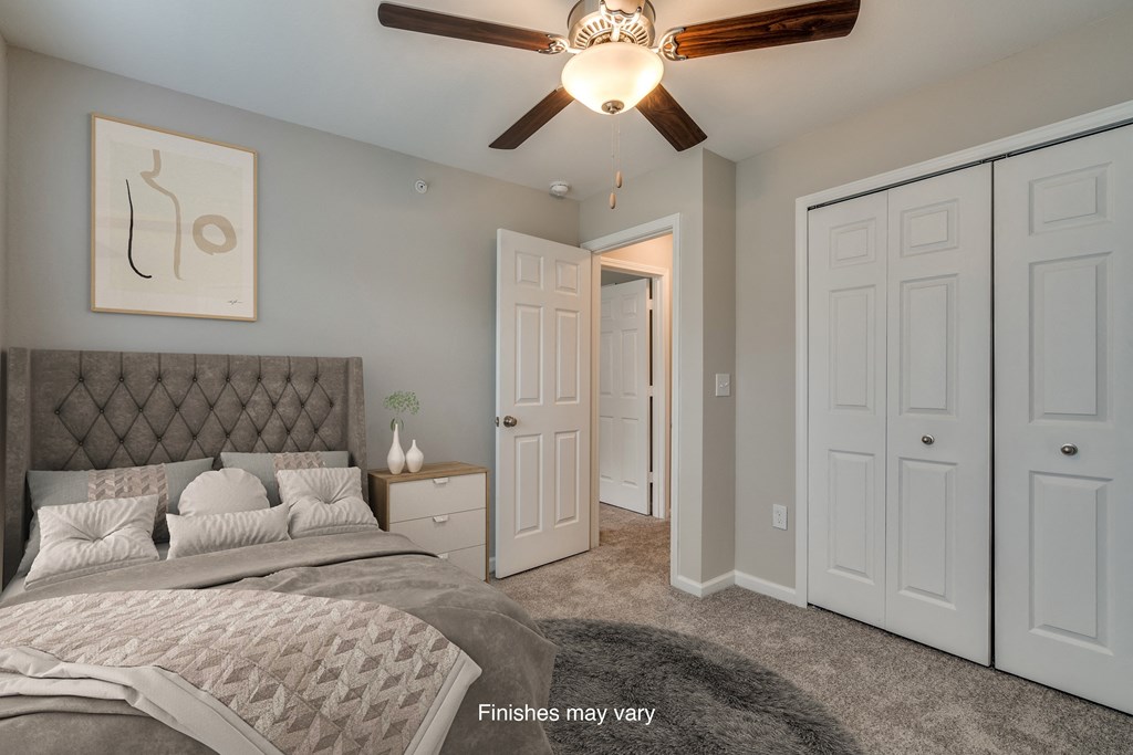 a bedroom with a bed and a ceiling fan  at Killian Lakes Apartments and Townhomes, Columbia