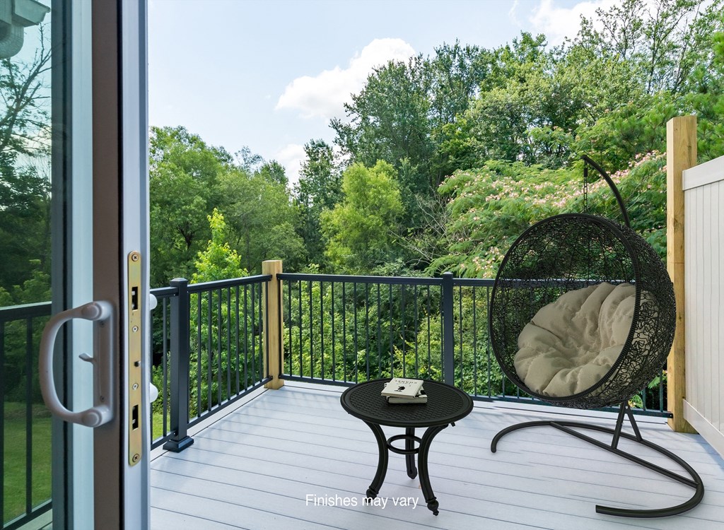 a balcony with a chair and a view of the woods  at Killian Lakes Apartments and Townhomes, Columbia, SC, 29203