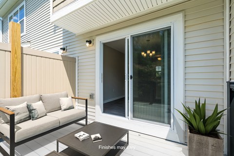a patio with a couch and a sliding glass door  at Killian Lakes Apartments and Townhomes, Columbia, SC, 29203