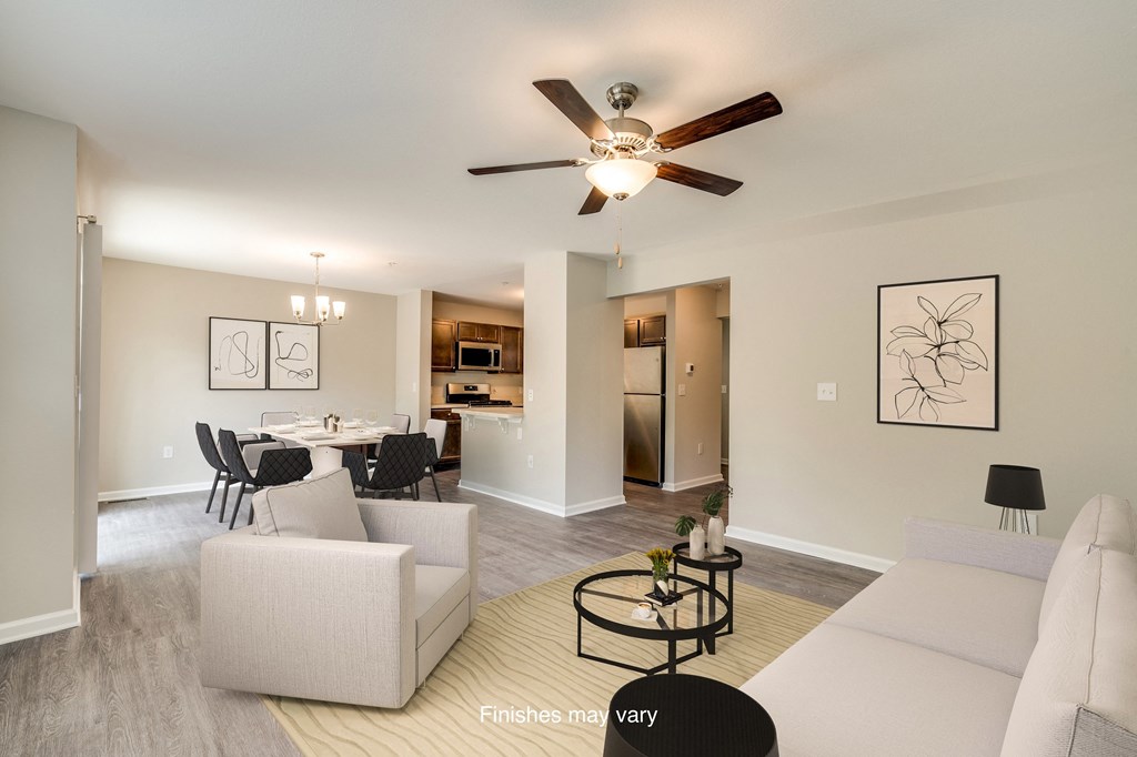 a living room and dining room with a ceiling fan  at Killian Lakes Apartments and Townhomes, Columbia