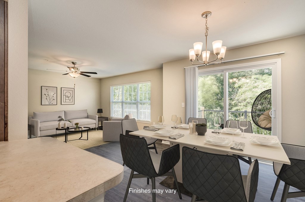 an open living room and dining room with a large window  at Killian Lakes Apartments and Townhomes, Columbia