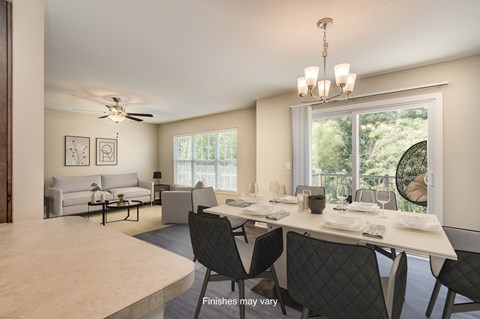 an open living room and dining room with a large window  at Killian Lakes Apartments and Townhomes, Columbia