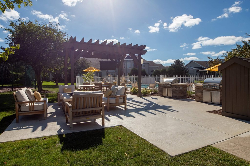a backyard patio with a pergola and a jacuzzi  at Mallard Bay Apartments, Crown Point