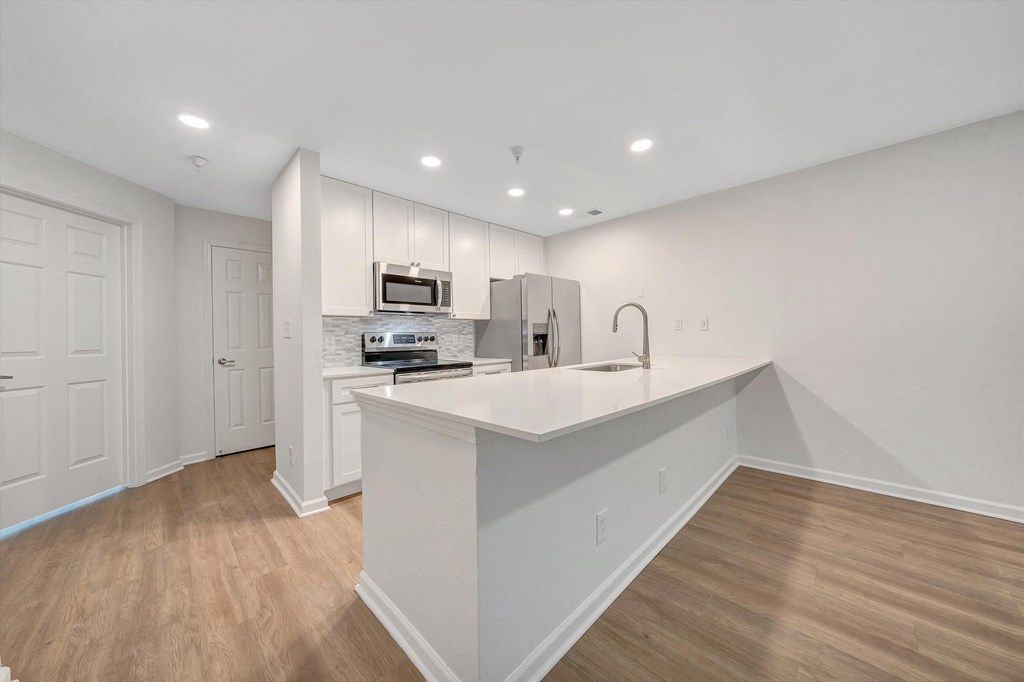 a kitchen with white cabinetry and a white quartz countertop  at The Vinings Apartments, Virginia