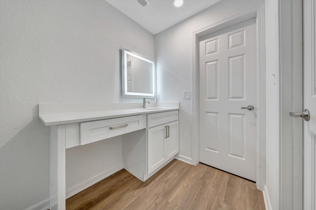 a bathroom with a vanity and mirror  at The Vinings Apartments, Richmond, Virginia