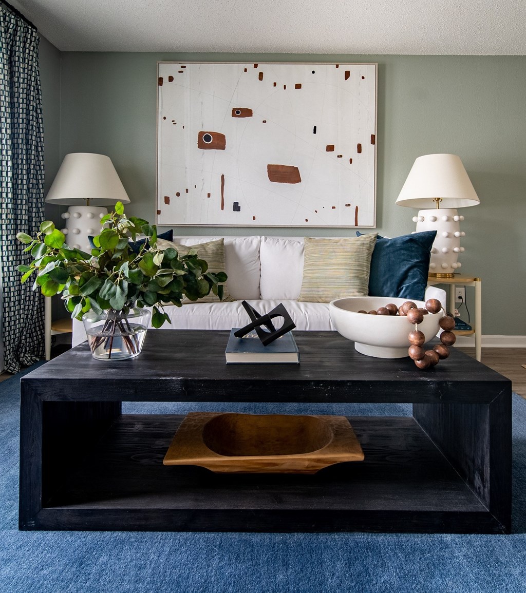 a living room with a coffee table and a painting on the wall  at The Vinings Apartments, Richmond, Virginia