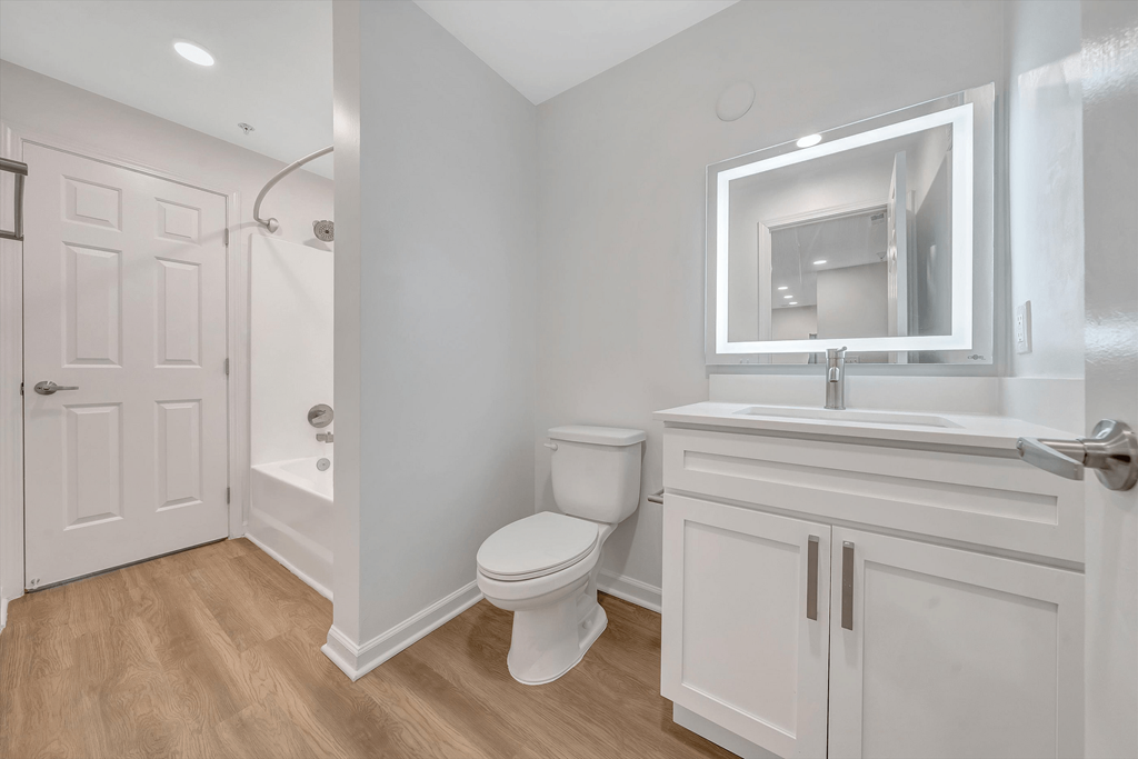 a bathroom with a toilet sink and shower  at The Vinings Apartments, Richmond, 23234