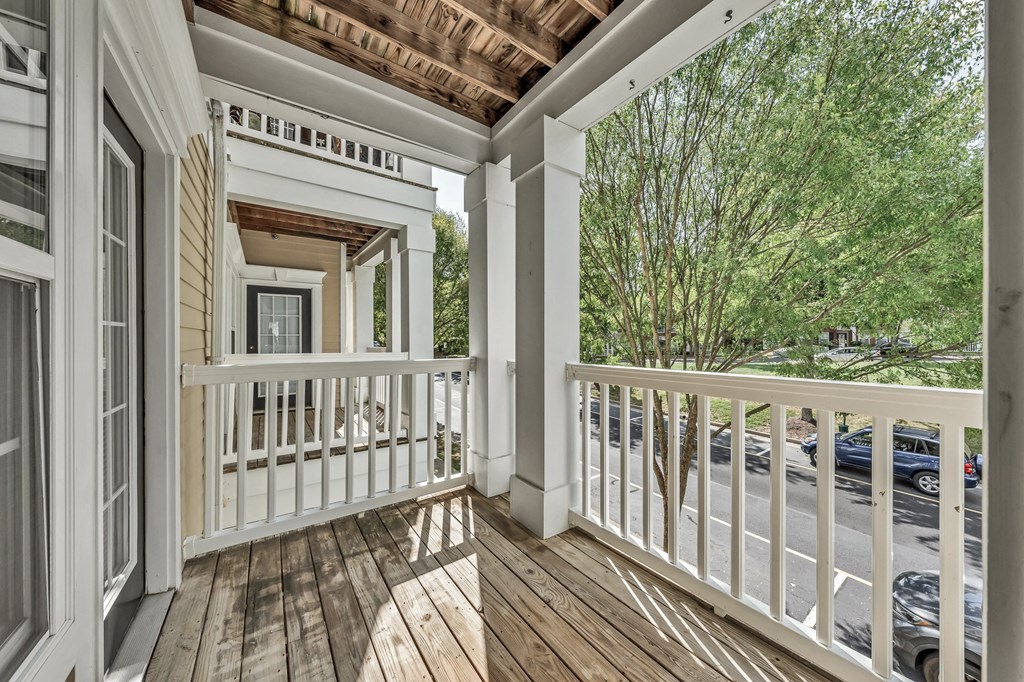 a covered porch with wood floors and white railings at Enclave Apartments, Midlothian, VA, 23114