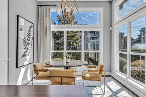 a dining room with large windows and a table and chairs at Trophy Club at Bellgrade, Midlothian, VA, 23113